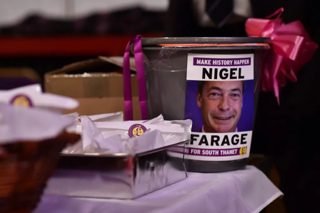 Donations bucket featuring Nigel Farage at a UKIP conference, Margate, 2015