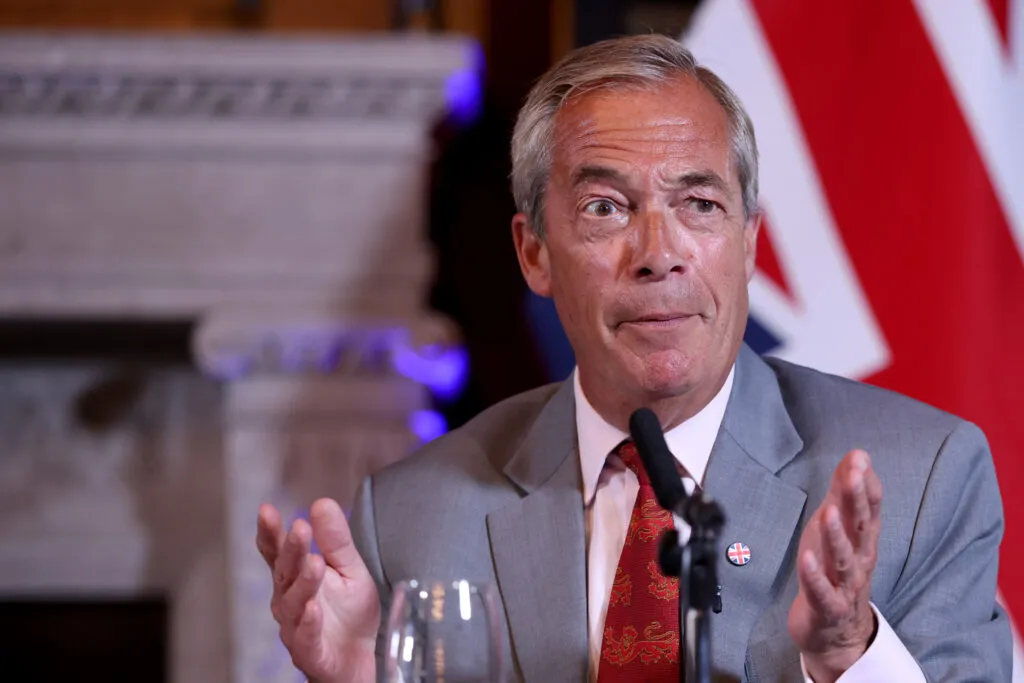 Nigel Farage gestures during a press conference on a plan to deport foreign prisoners