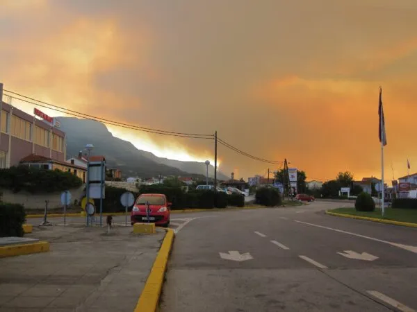 Smoke plumes over a coastal town
